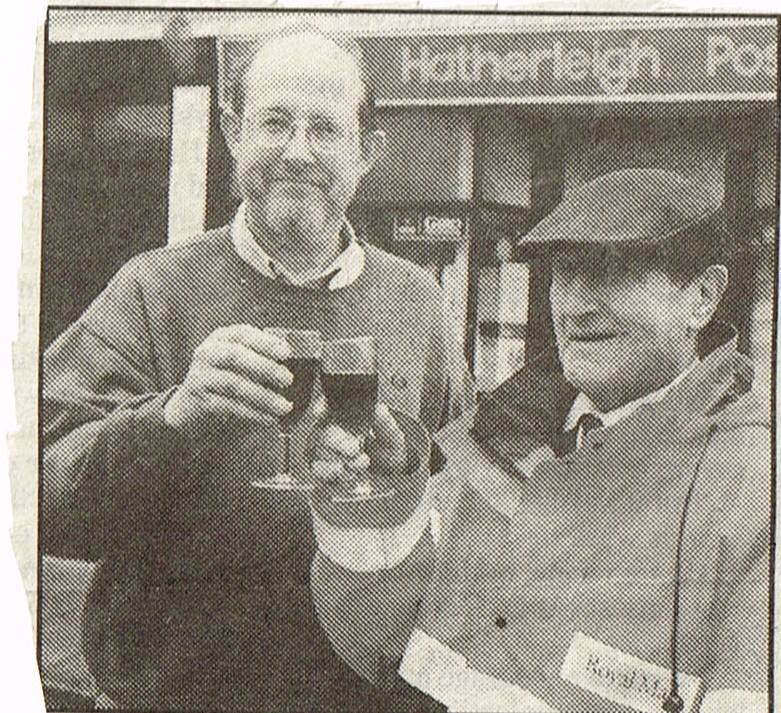 Drew Williams the Post Master at Hatherleigh toasts George Searle's retirement
